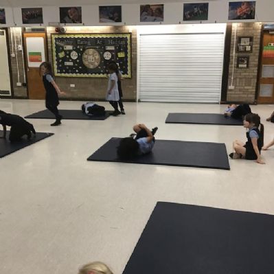 Gymnastics exploring and practicing rolls